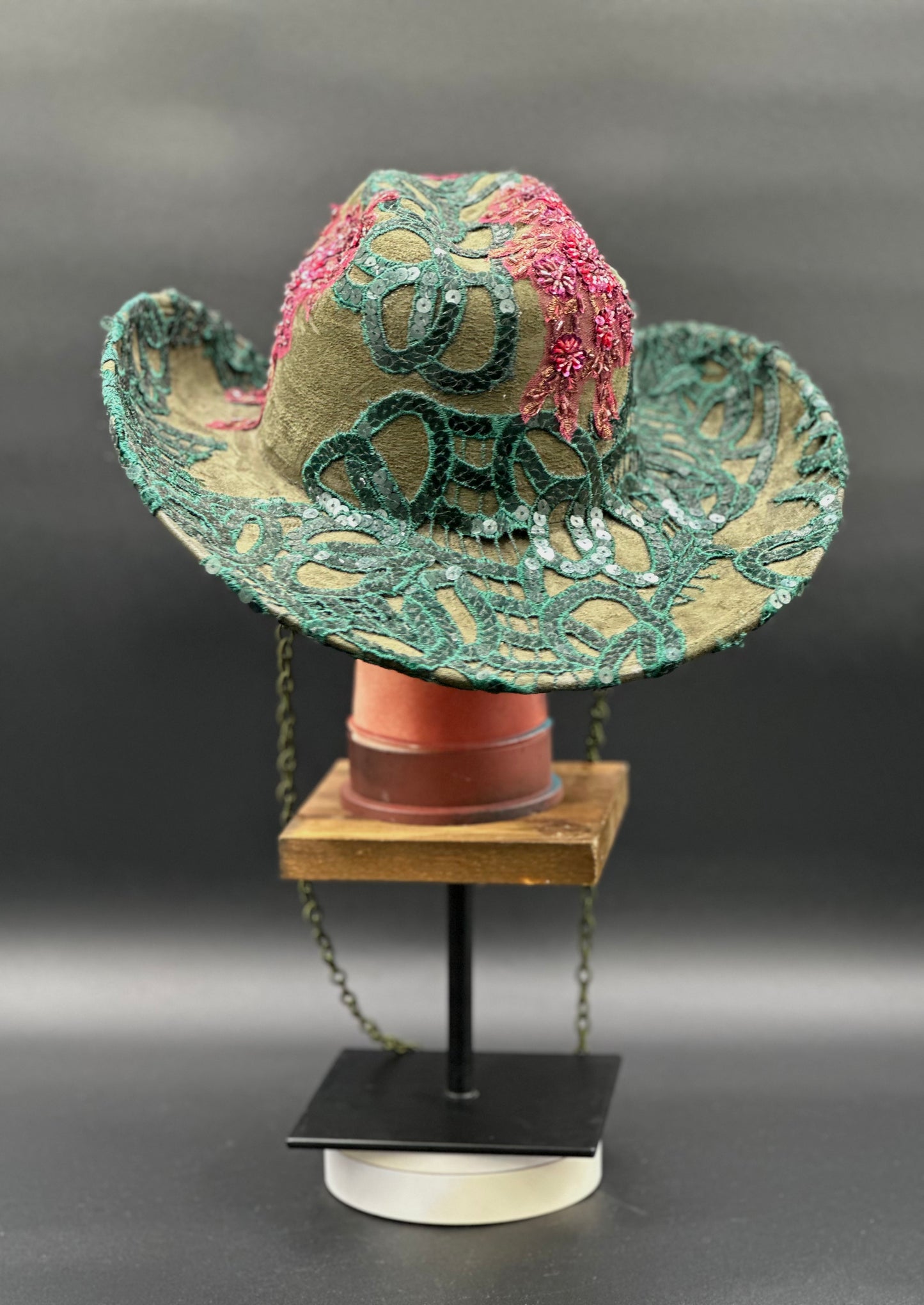 Back view of the Deep Forest Green Suede Cowboy Hat on a mannequin head, showing the full design and details from the rear.