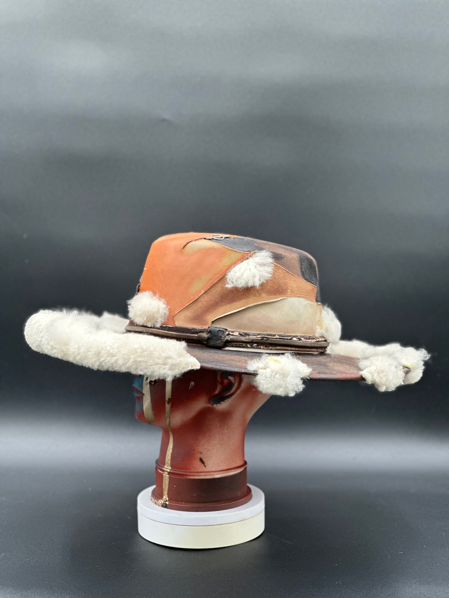 Side view of the Dinamarca Caramel Cordobés Hat, highlighting the sheep fur wing placement and the hat's silhouette.