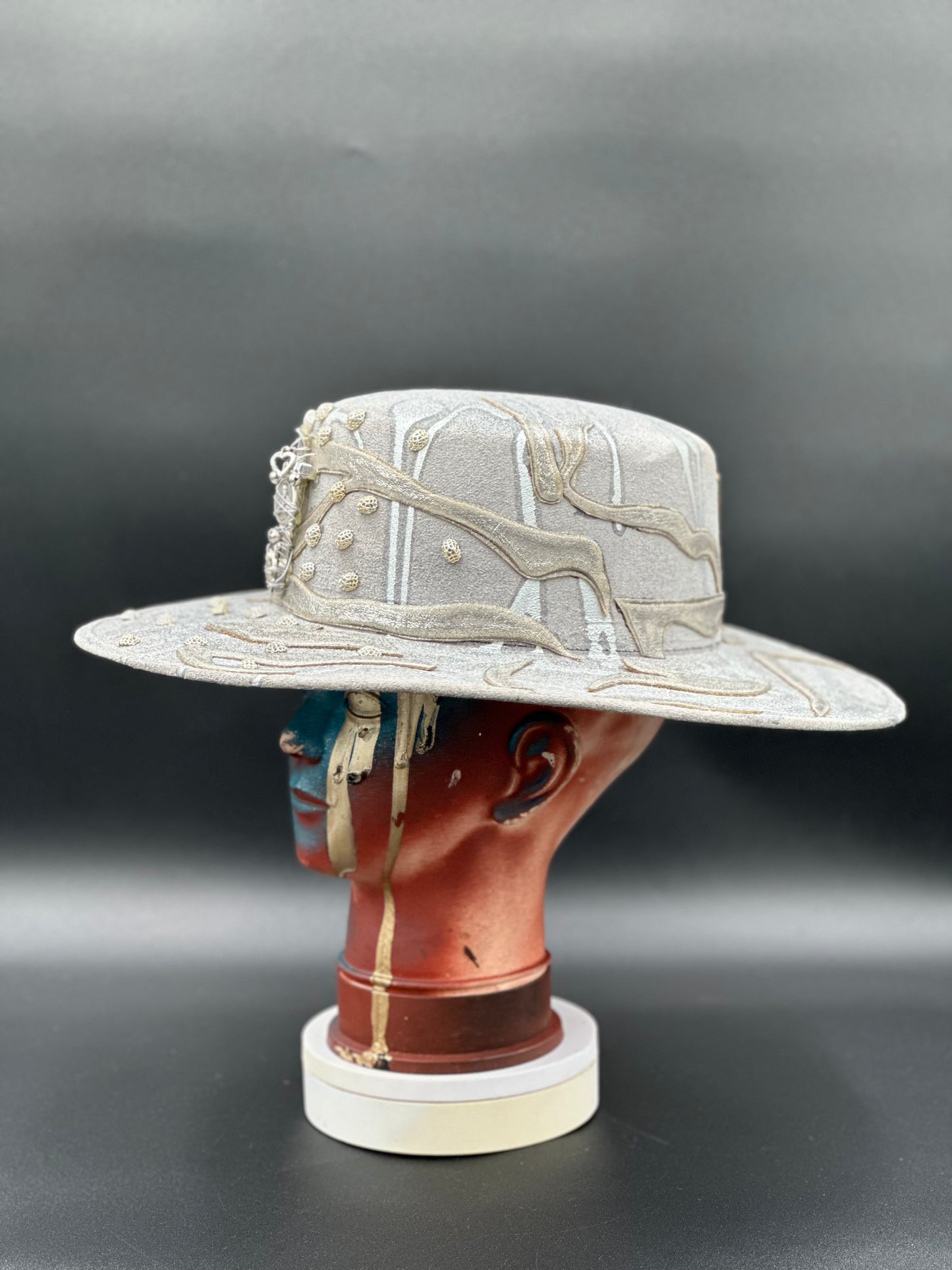 Ibiza Hand-Painted Silver Glitter Cordobés Hat on a mannequin head, showcasing the hat's sparkling style and unique design.