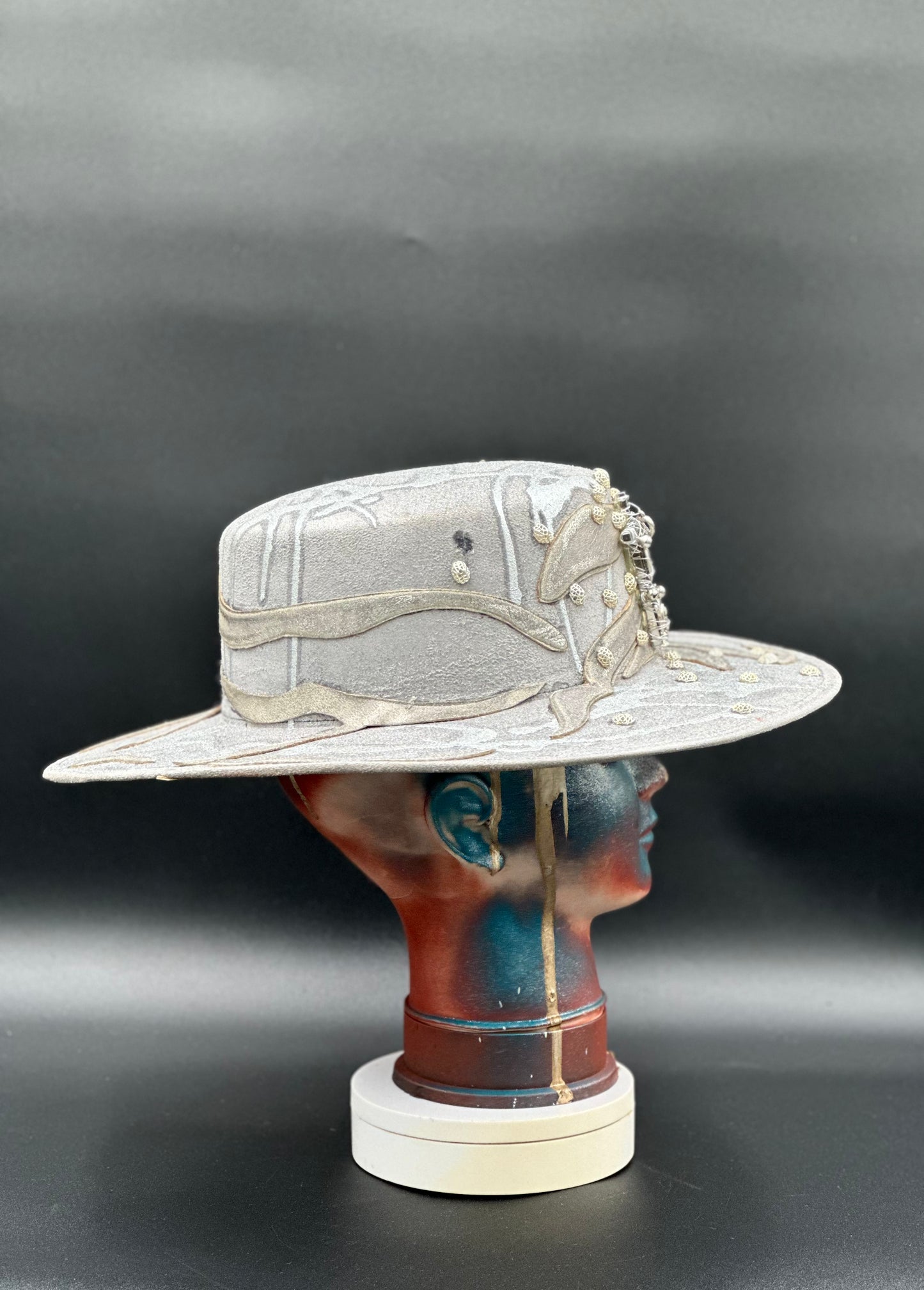 Side view of the Ibiza Silver Glitter Cordobés Hat on a mannequin head, highlighting the cross placement and the hat's silhouette.