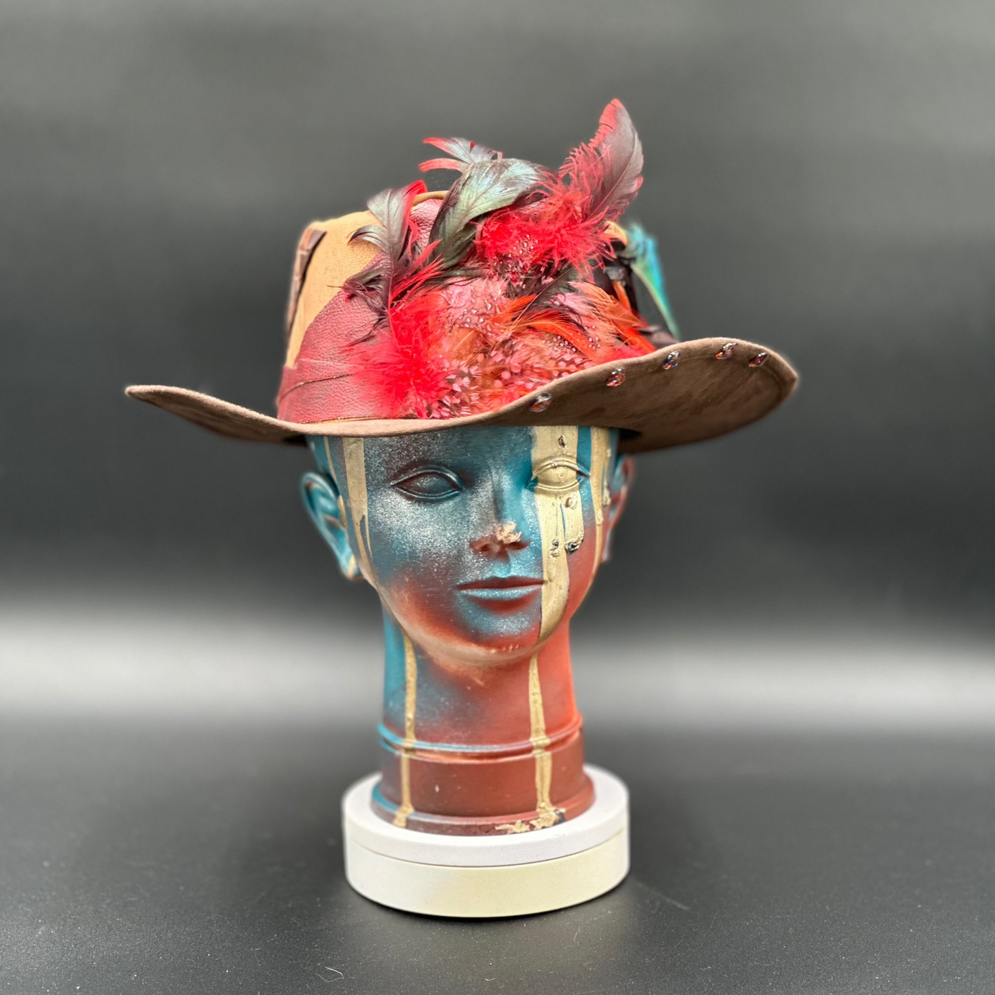 Madagascar Crimped Tobacco Cordobés Hat with feathers, intricate charms, and a mix of premium leathers. Front view showing the hat's full design and shape.