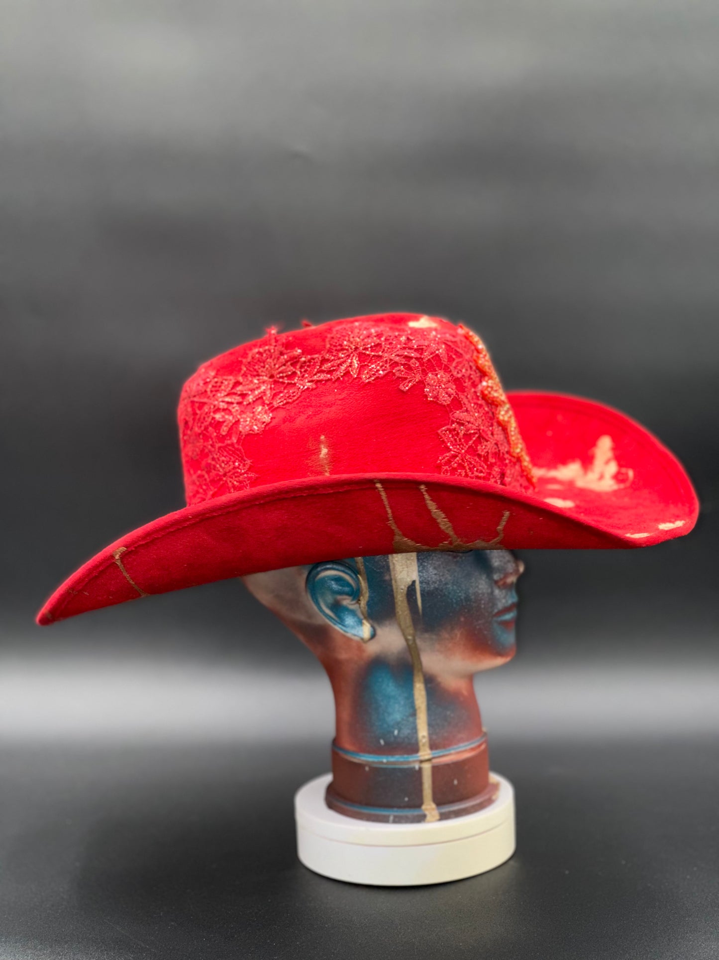Side view of the Miami Beach Red Suede Hat on a mannequin head, highlighting the hat's classic silhouette.