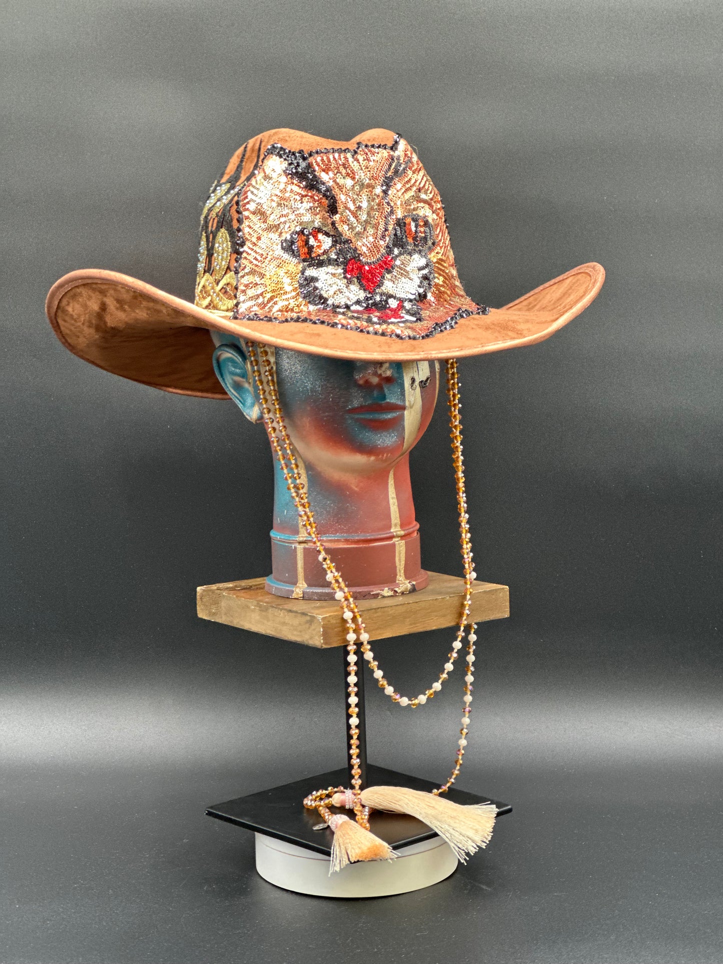 Angled view of the Tennessee Camel Suede Cowboy Hat on a mannequin head, displaying the texture of the suede and the placement of the embroidered tiger and crystal chain.