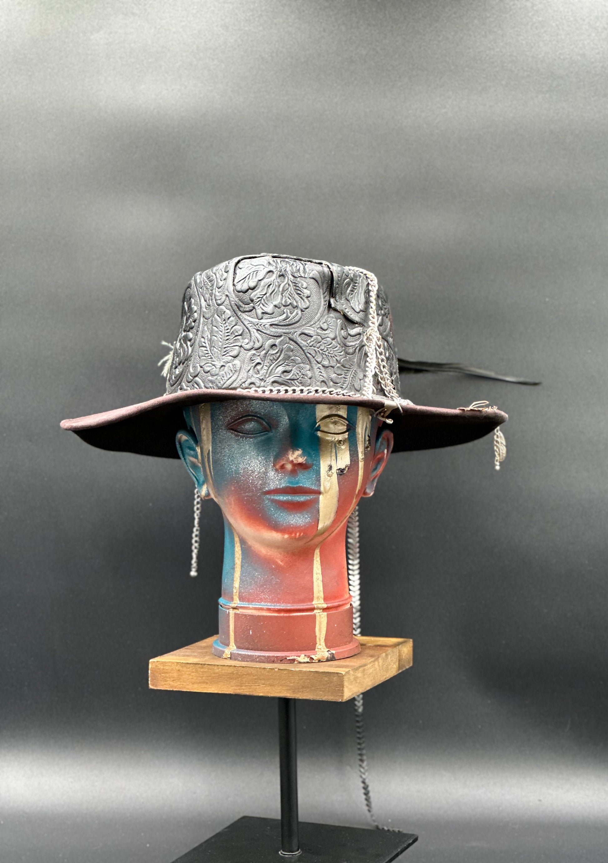 Algarve Black Cordobés Suede Hat with carved leather accents, chains, and unique charms. Front view showing the hat's full design and shape.