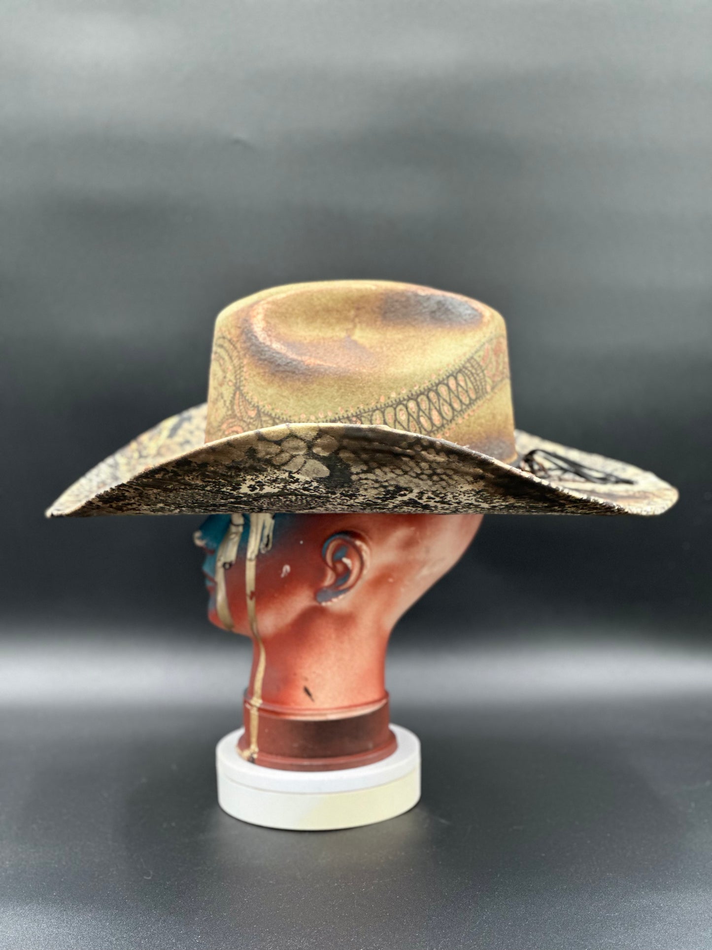 Side view of the Australia Snake - Green Wool Cowboy Hat, showcasing the burnt drill print.