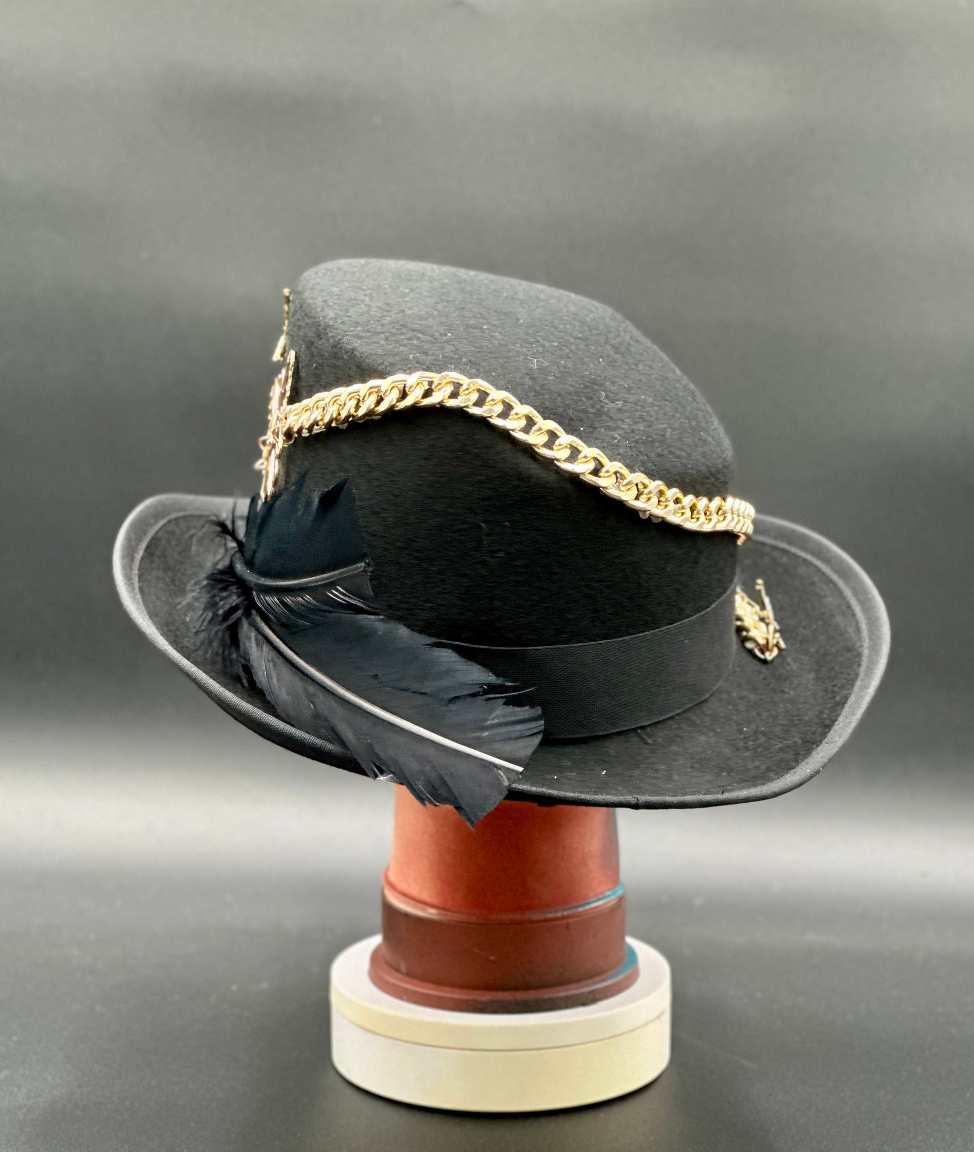Close-up of the Berlin Black Wool Top Hat showing the detailed gold chains, spikes, and intricate heart embellishments.