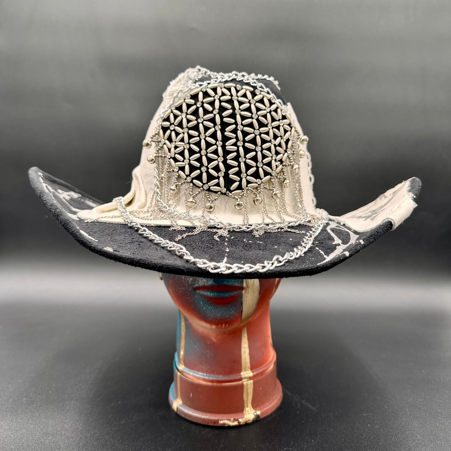 Canada - Black Wool Cowboy Hat with leather band, chains, and metal centerpiece, front view.