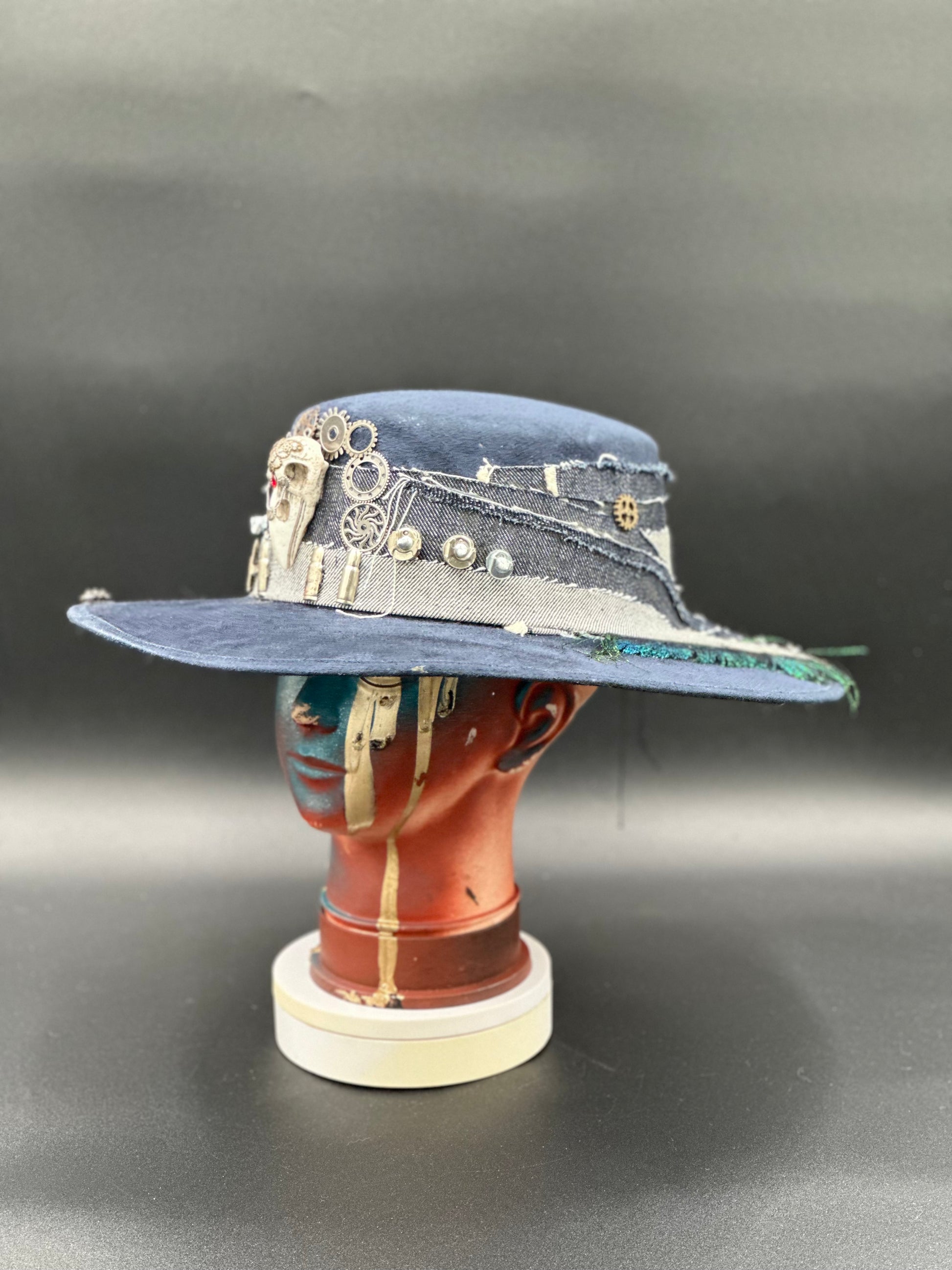 Side view of the Coachella Blue Suede Cordobés Hat, highlighting the unique charm placement and the hat's shape.