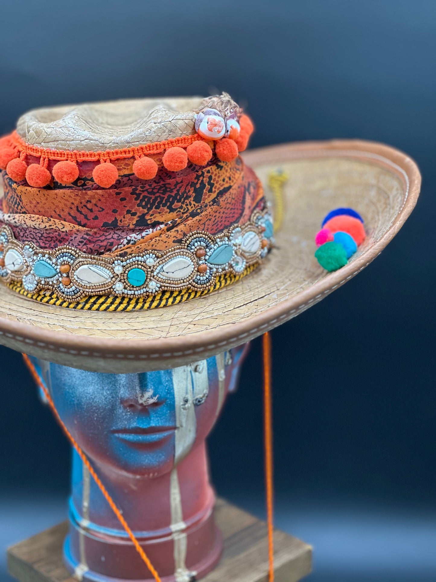 Angled view of the Colombia Straw Hat, showing the texture of the straw, embellishments, and overall shape.