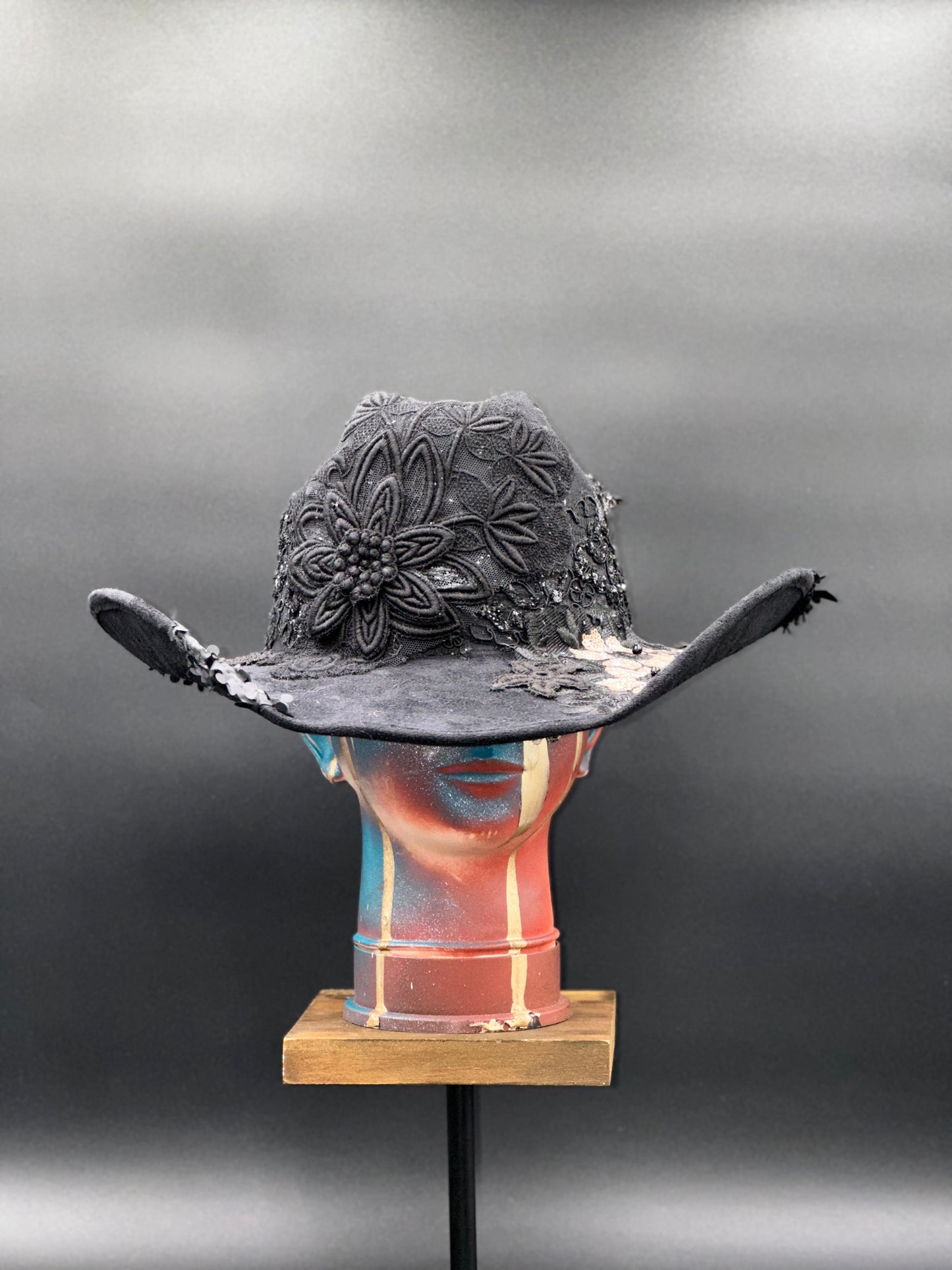 Close-up of the embroidered crochet centerpiece on the Zorro Black Suede Cowboy Hat, highlighting the artistic details, displayed on a mannequin head.