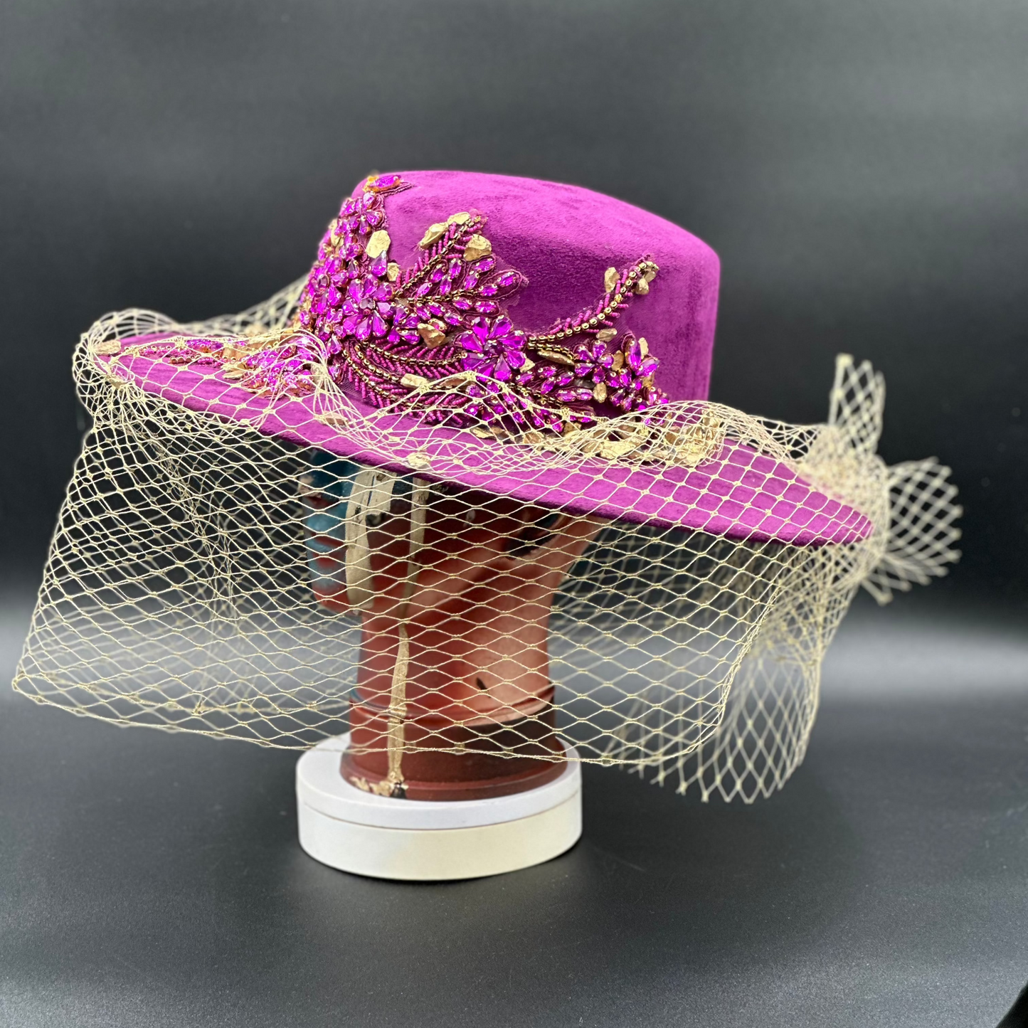 Side view of the France Magenta Cordobés Wool Hat on a mannequin head, highlighting the crystal placement and the hat's silhouette.