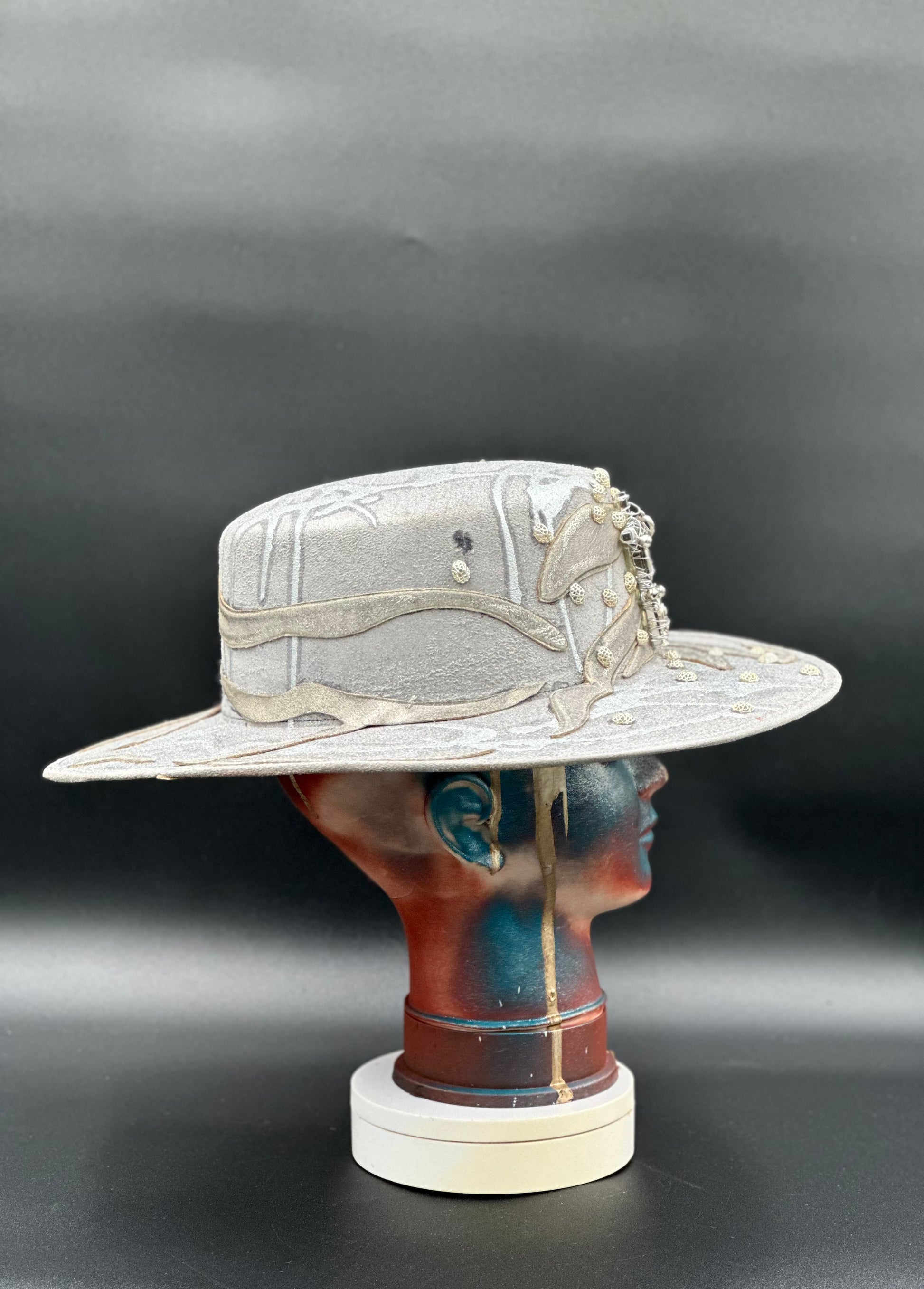 Side view of the Ibiza Silver Glitter Cordobés Hat on a mannequin head, highlighting the cross placement and the hat's silhouette.