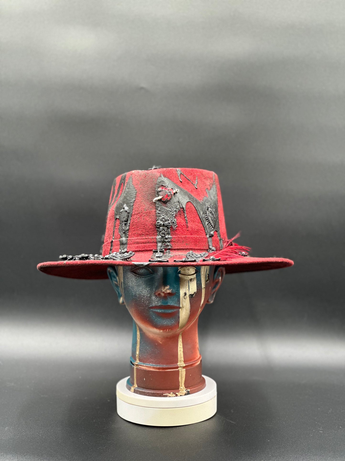 Madrid Red Arrow Suede Hat with black lava drops and charms. Front view showing the hat's full design and shape.