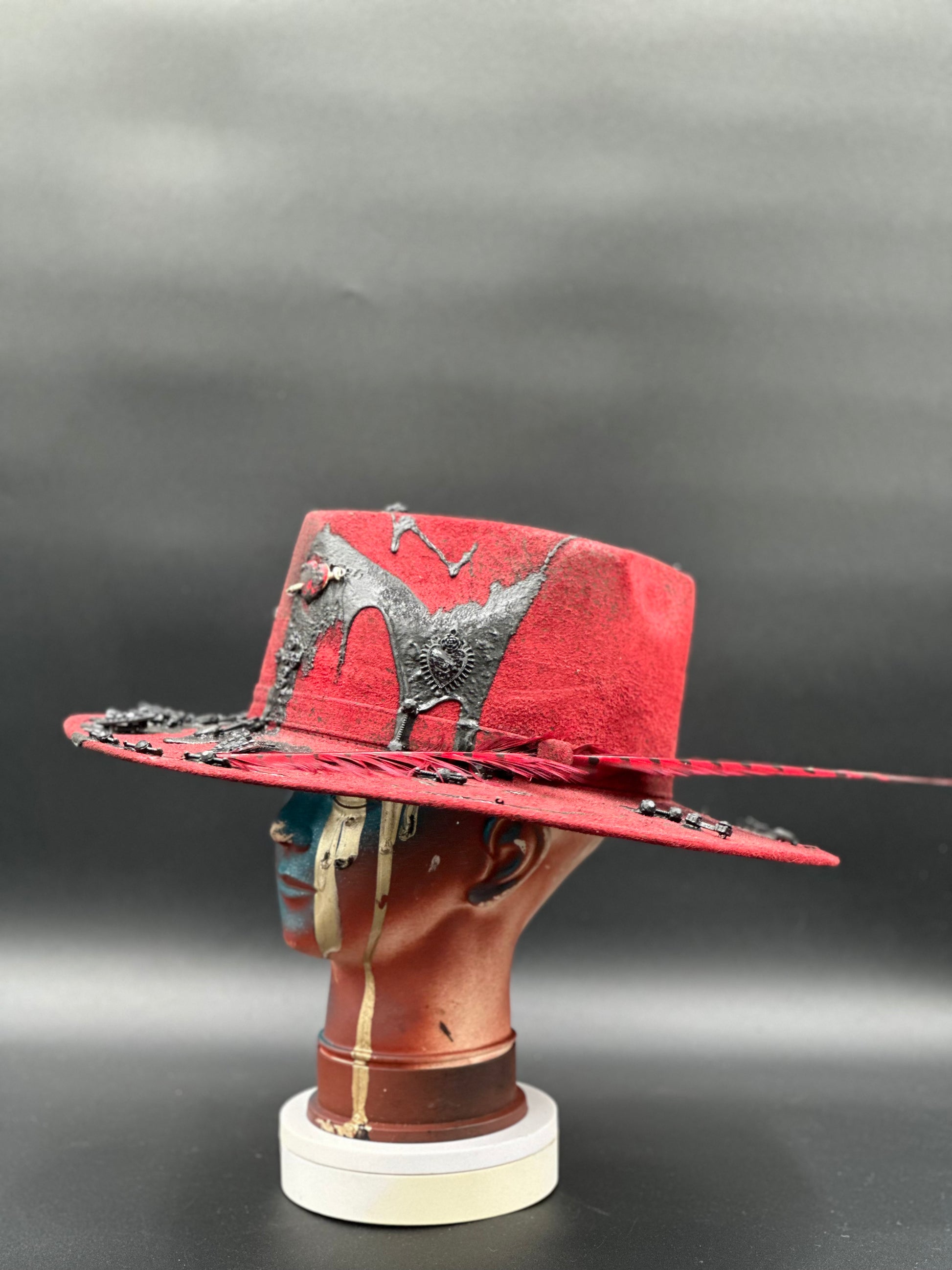 Side view of the Madrid Red Arrow Suede Hat, highlighting the charm placement