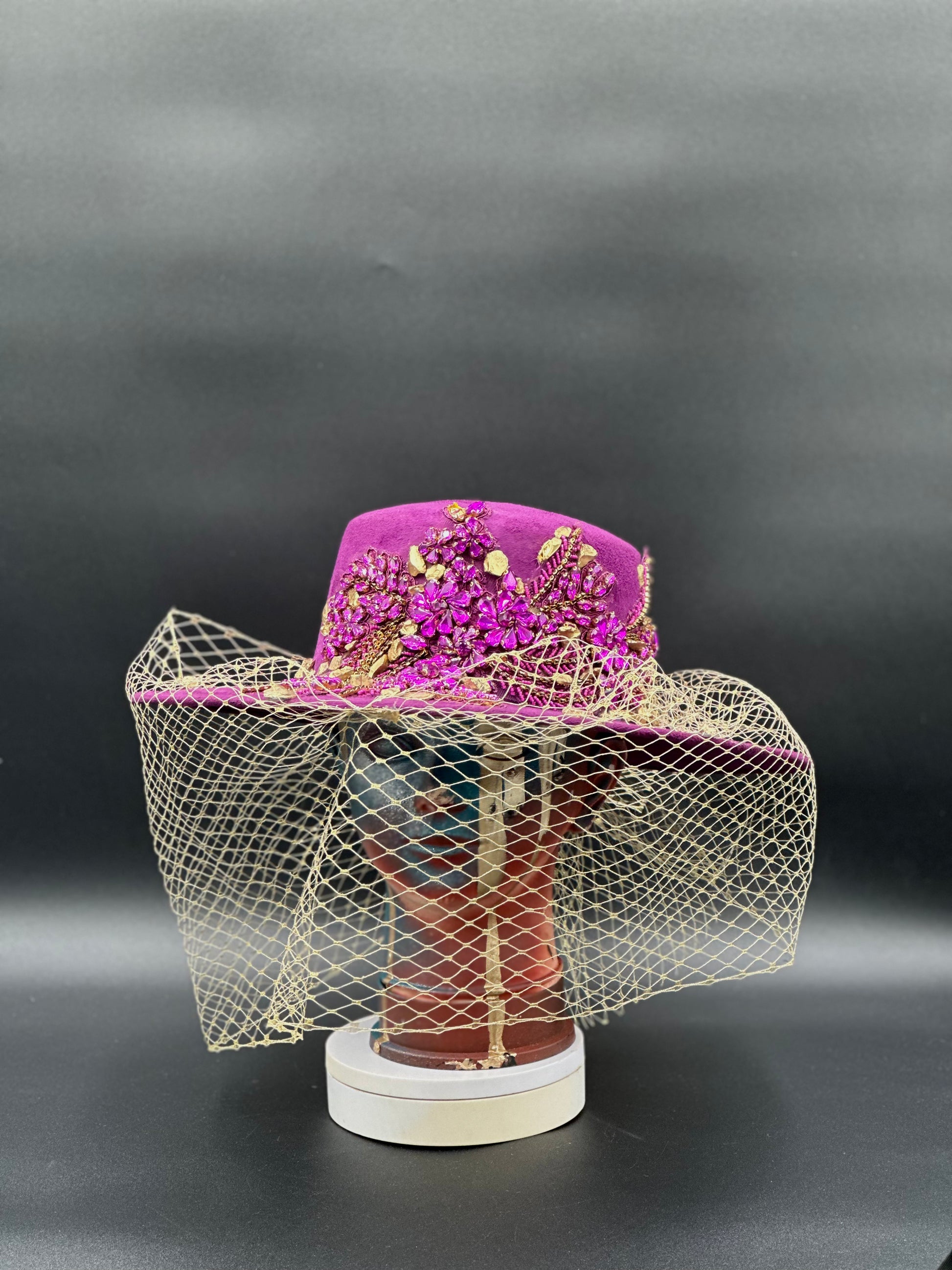 France Magenta Cordobés Wool Hat on a mannequin head, showcasing the hat's vibrant color and elegant style.