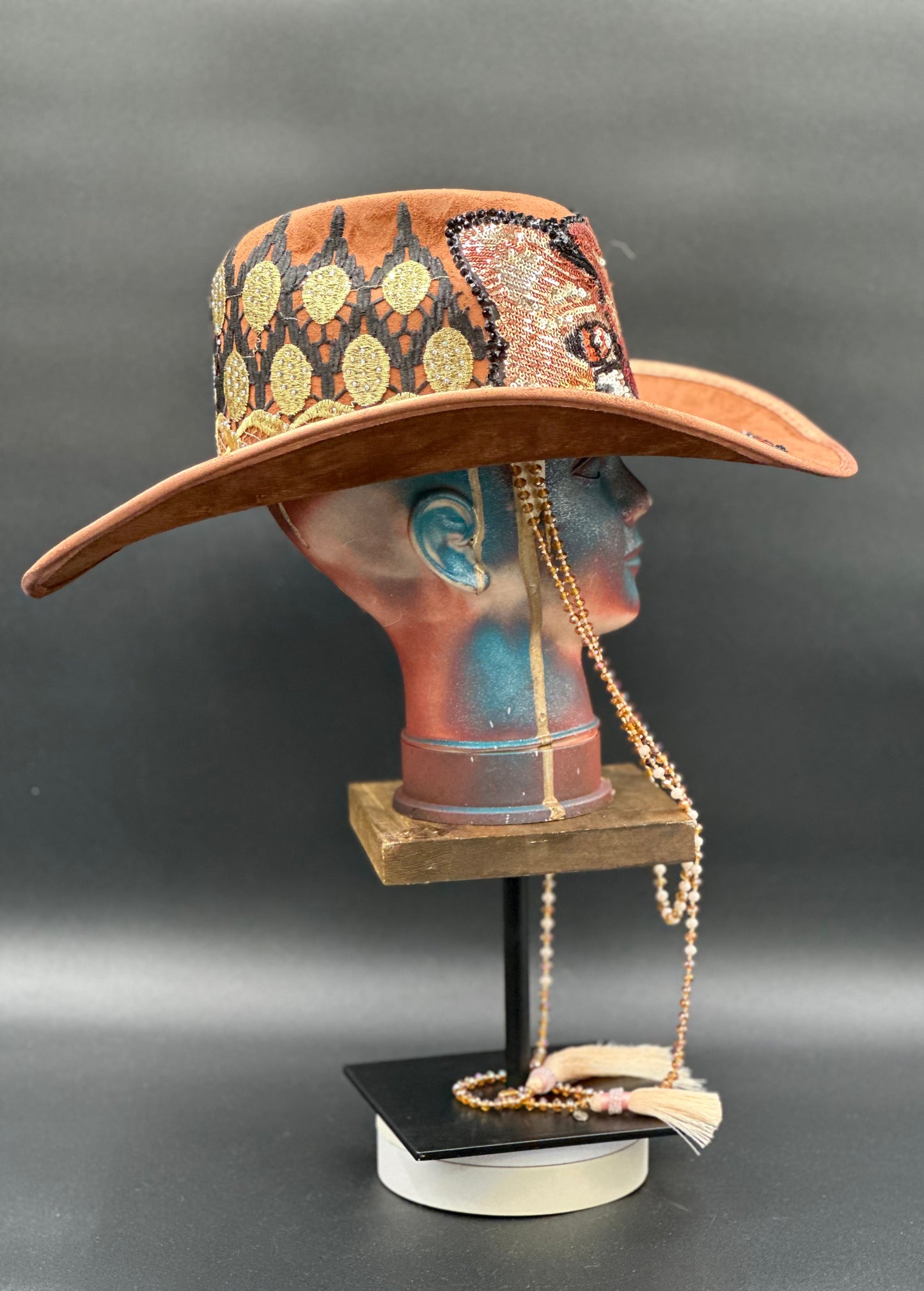 Tennessee Camel Suede Cowboy Hat on a mannequin head, showcasing the hat's rugged elegance and unique style.