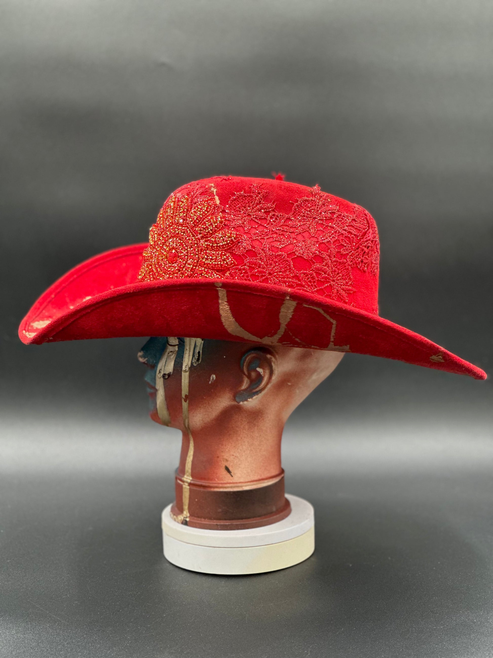 Angled view of the Miami Beach Red Suede Hat on a mannequin head, displaying the texture of the suede and the hat's overall design.