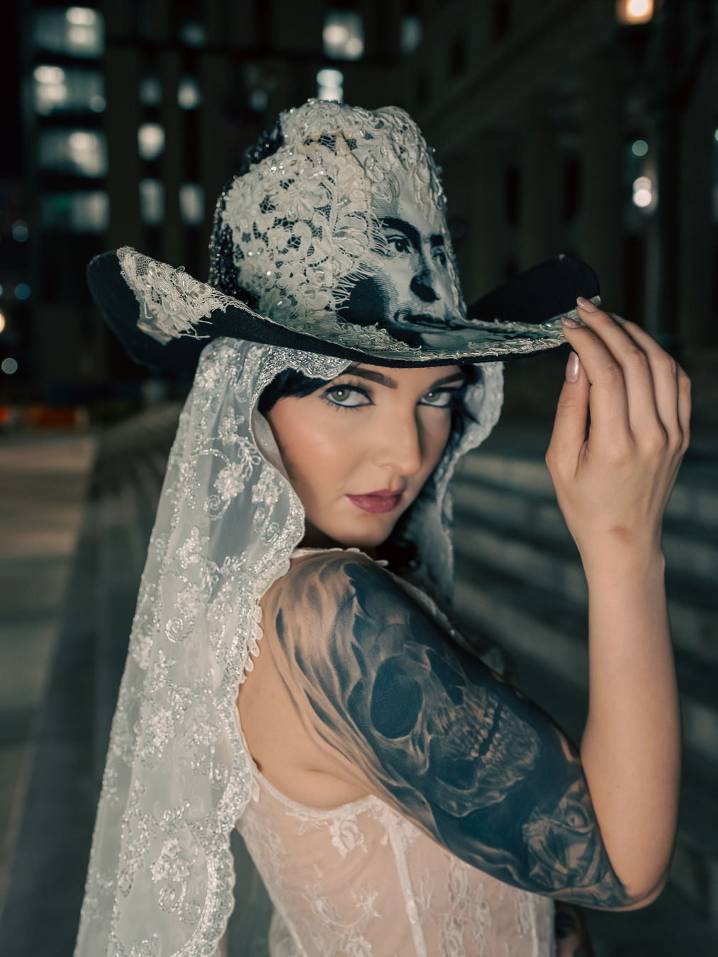 Model wearing the Wedding of Frida and Death Cowboy Hat, styled with a dramatic, artistic outfit. Shows the hat's statement-making appeal.