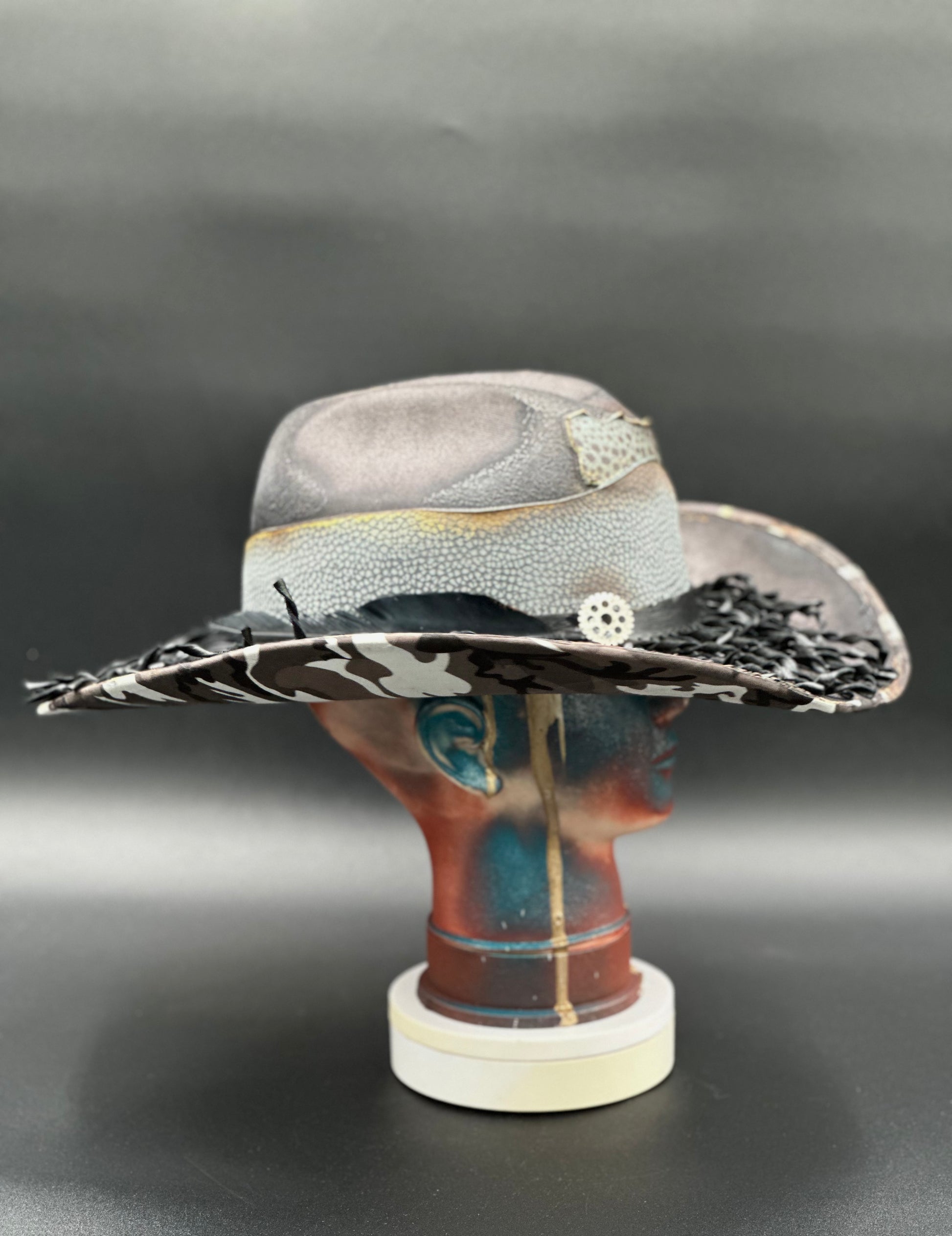 Side view of the Nashville Gray Wool Cowboy Hat on a mannequin head, highlighting the camouflage print placement and the hat's silhouette.