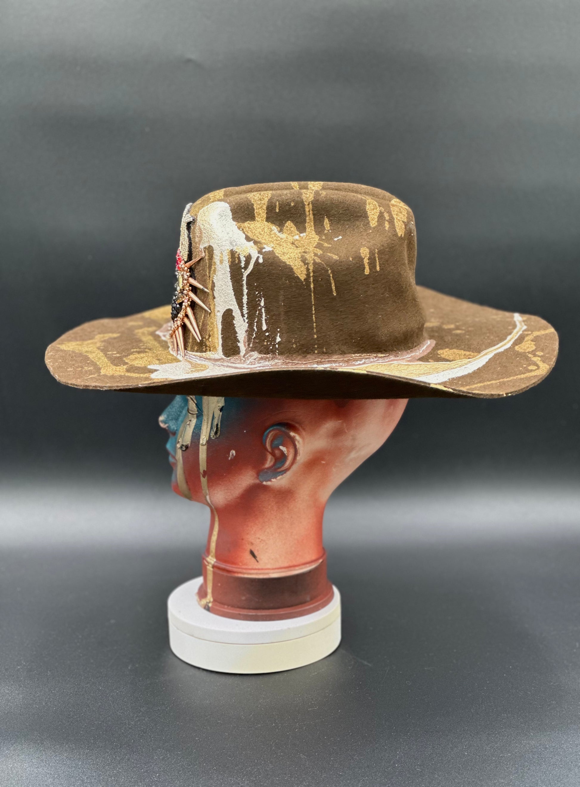 Side view of the North Carolina Tobacco Wool Cowboy Hat on a mannequin head, highlighting the heart-shaped spike placement and the hat's silhouette.