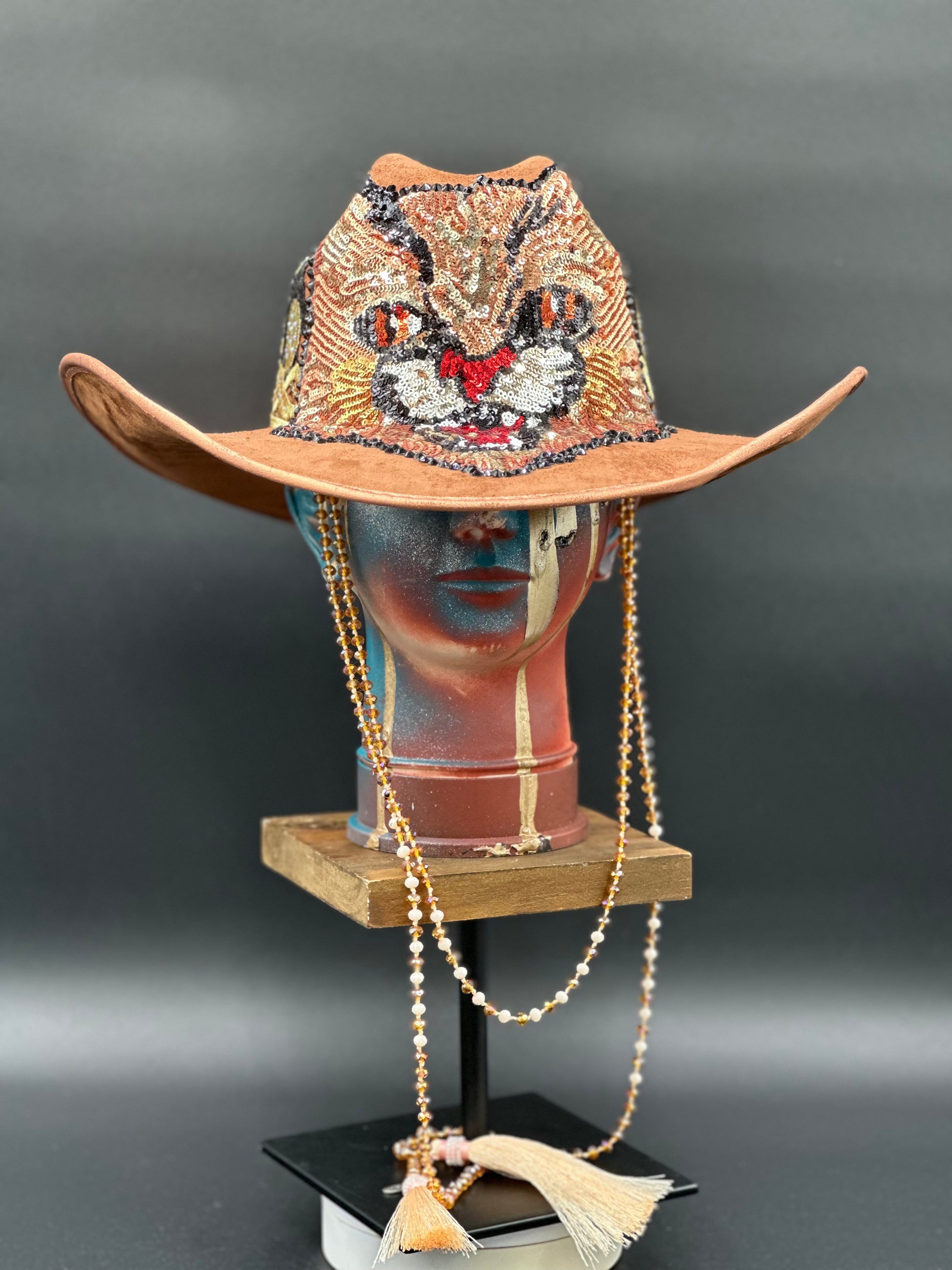 Tennessee Camel Suede Cowboy Hat with an embroidered tiger centerpiece and a crystal chain displayed on a mannequin head. Front view showing the hat's full design and shape.
