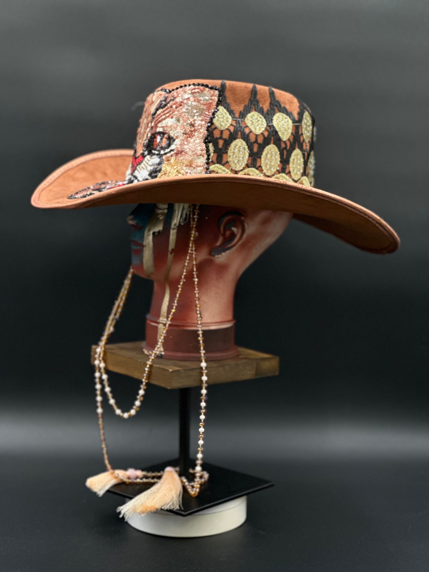 Side view of the Tennessee Camel Suede Cowboy Hat on a mannequin head, highlighting the crystal chain placement and the hat's silhouette.