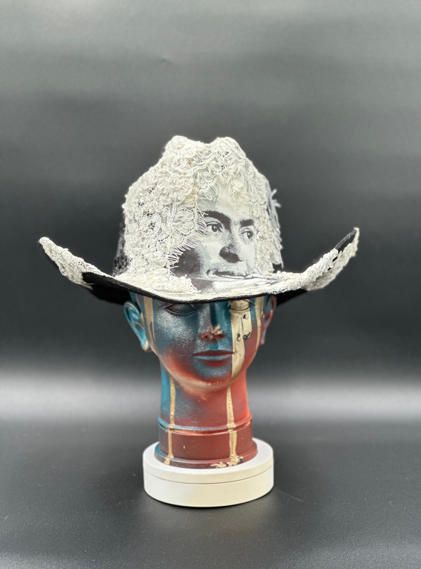 Wedding of Frida and Death Black Wool Cowboy Hat with a Frida Kahlo print, lace, and charms. Front view showing the full design and silhouette.