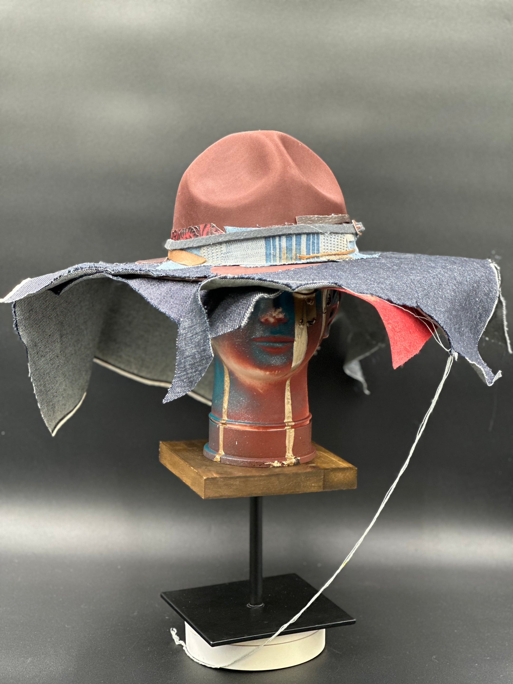 Totally Me Tobacco Ranger Hat with layered denim and leather, showing a wide brim and unique fabric textures. 