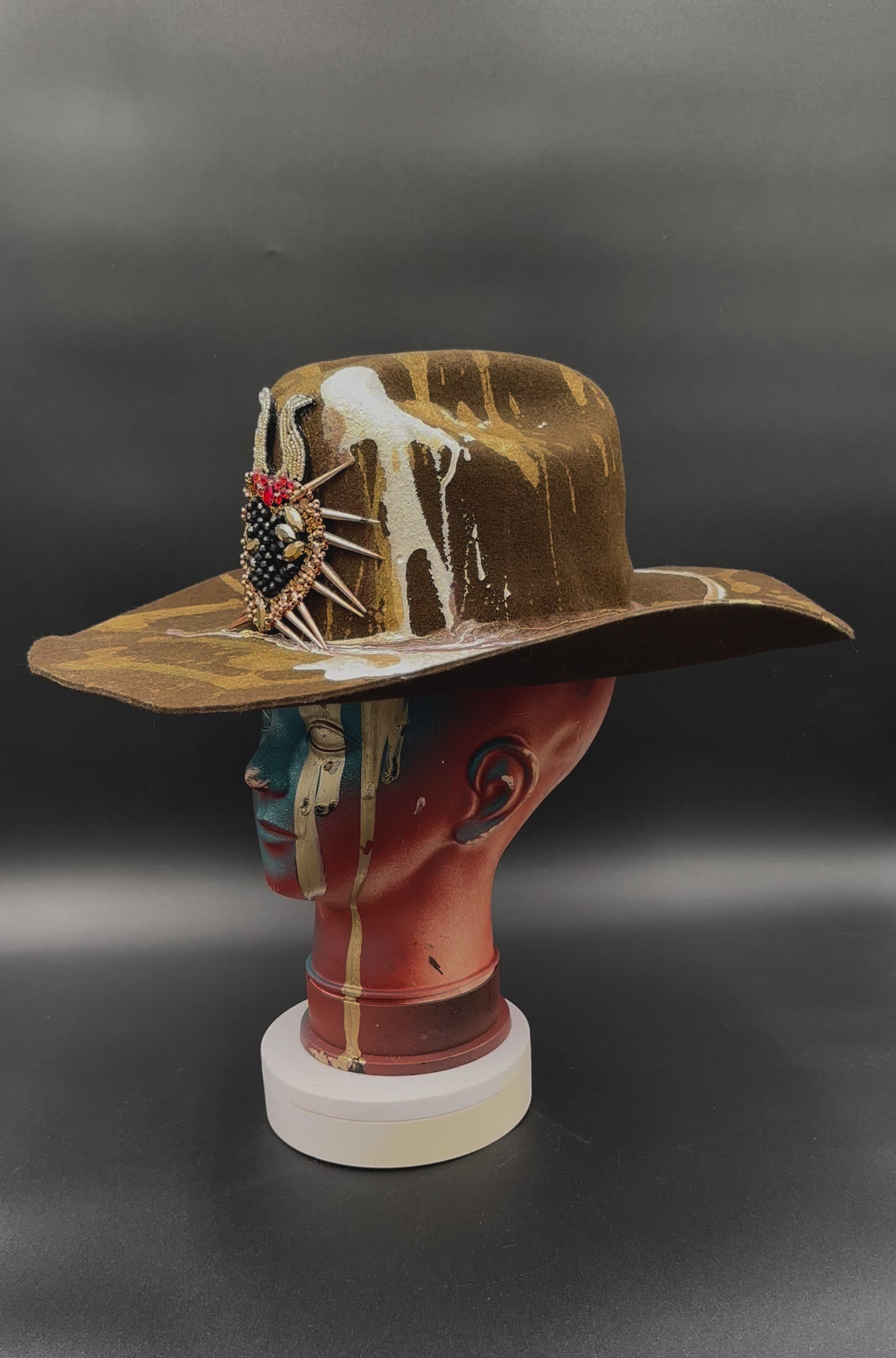 360-degree video of the North Carolina Tobacco Wool Cowboy Hat rotating on a mannequin head, showcasing the hat's full design, tobacco wool texture, pearl and gold accents, and heart-shaped spike detail from all angles.