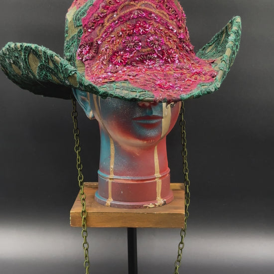 360-degree video of the Deep Forest Green Suede Cowboy Hat rotating on a mannequin head, showcasing the hat's full design, green suede texture, emerald embroidery, stoned lace centerpiece, and shimmering embellishments from all angles.