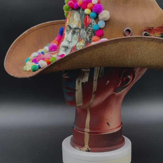 360-degree video of the Frida in Cotton - Brown Straw Cowboy Hat rotating on a mannequin head, showcasing the hat's full design, colorful embellishments, and straw texture from all angles.