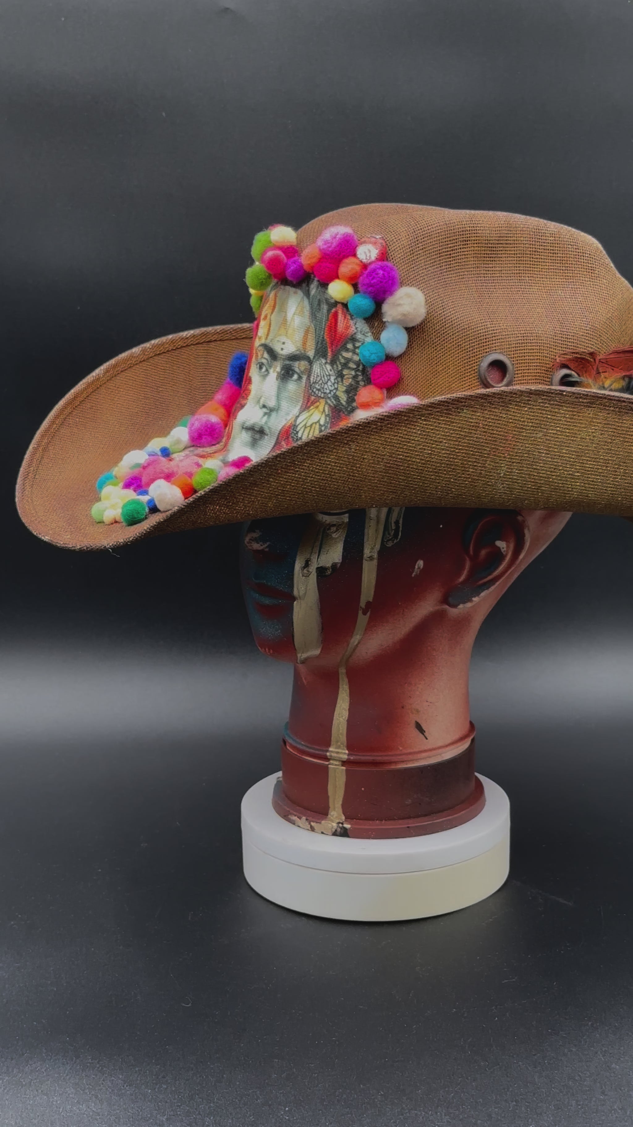 360-degree video of the Frida in Cotton - Brown Straw Cowboy Hat rotating on a mannequin head, showcasing the hat's full design, colorful embellishments, and straw texture from all angles.