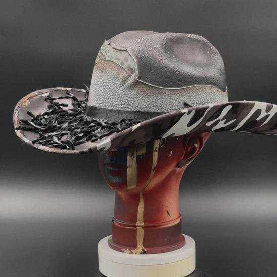 360-degree video of the Nashville Gray Wool Cowboy Hat rotating on a mannequin head, showcasing the hat's full design, camouflage print, mixed leathers, and torch technique from all angles.