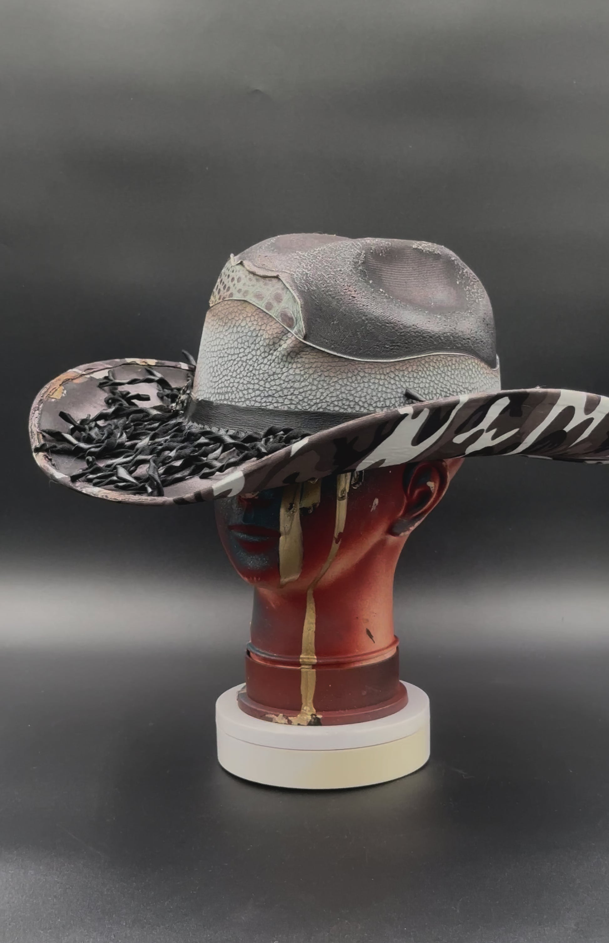 360-degree video of the Nashville Gray Wool Cowboy Hat rotating on a mannequin head, showcasing the hat's full design, camouflage print, mixed leathers, and torch technique from all angles.